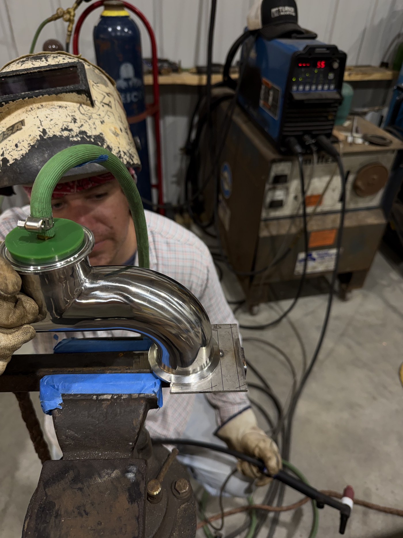 Stainless T-fitting set up on custom jig with purge dam ready for welding